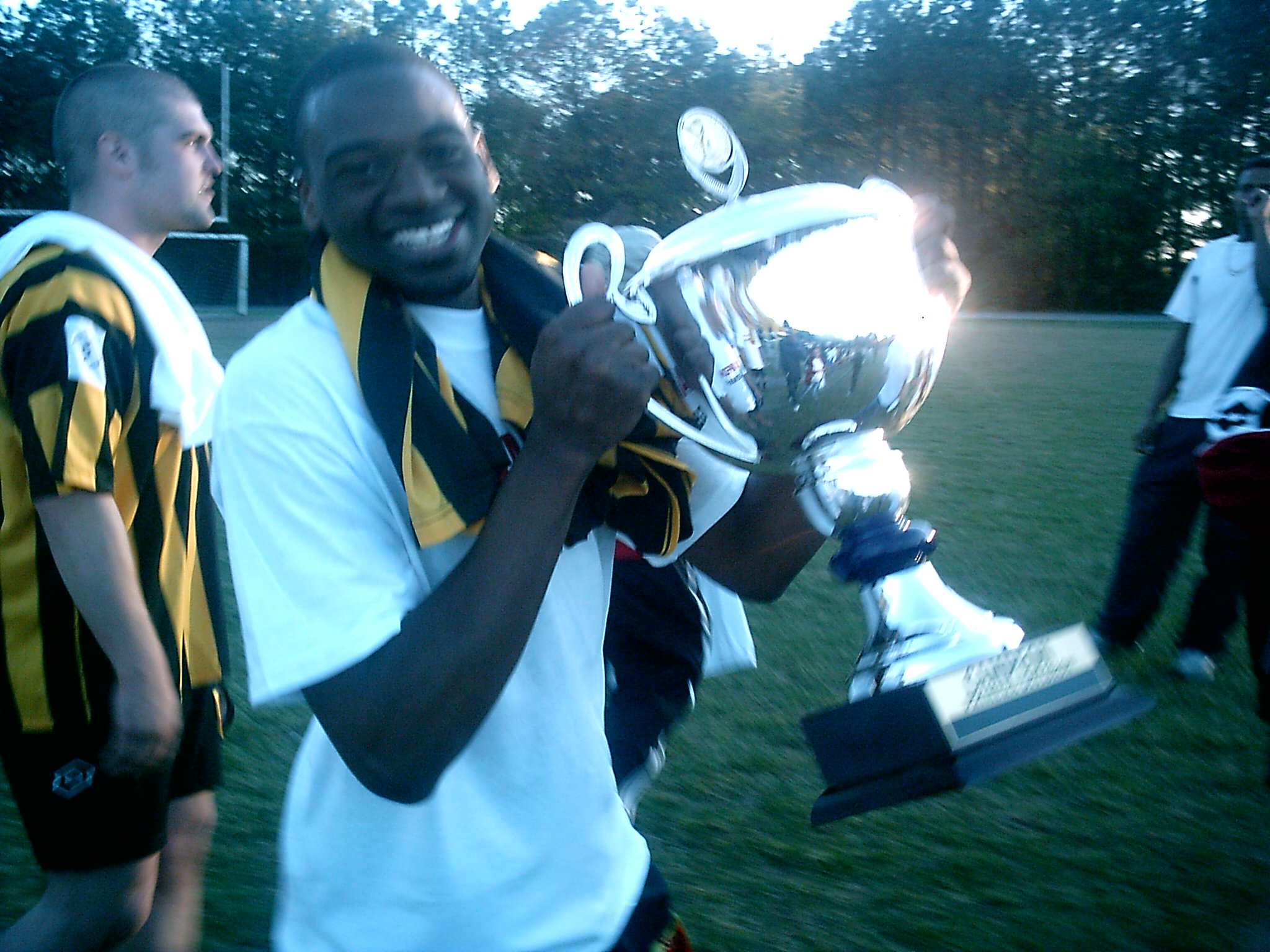 tinashe kusema holding a trophy